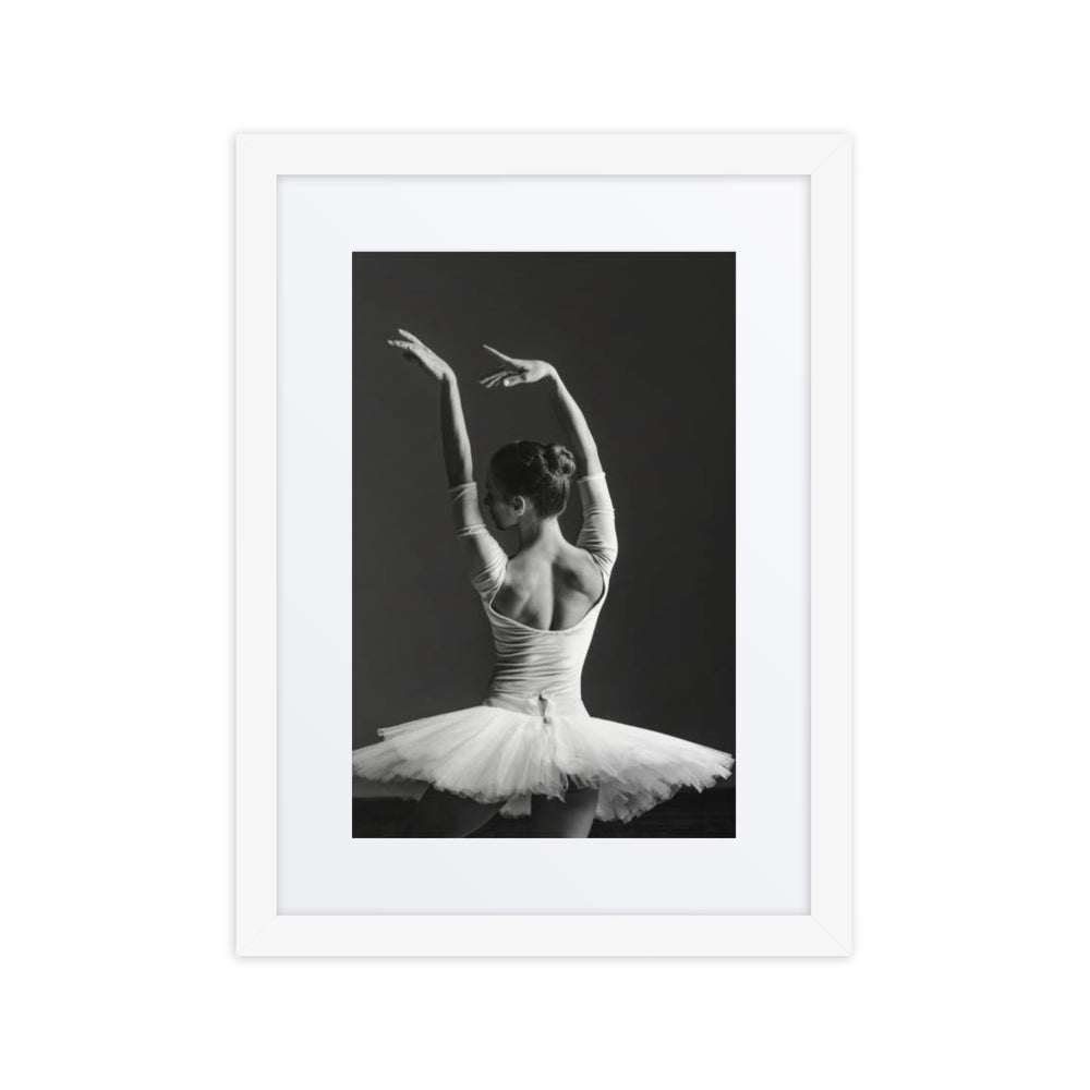 A monochrome image of a ballerina captured from behind, elegantly poised with arms raised, exuding timeless grace and poise in a classical tutu.