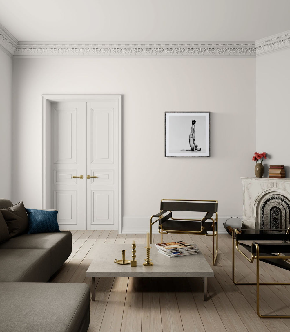 Modern living room with gray sofa, coffee table, and decorative items.