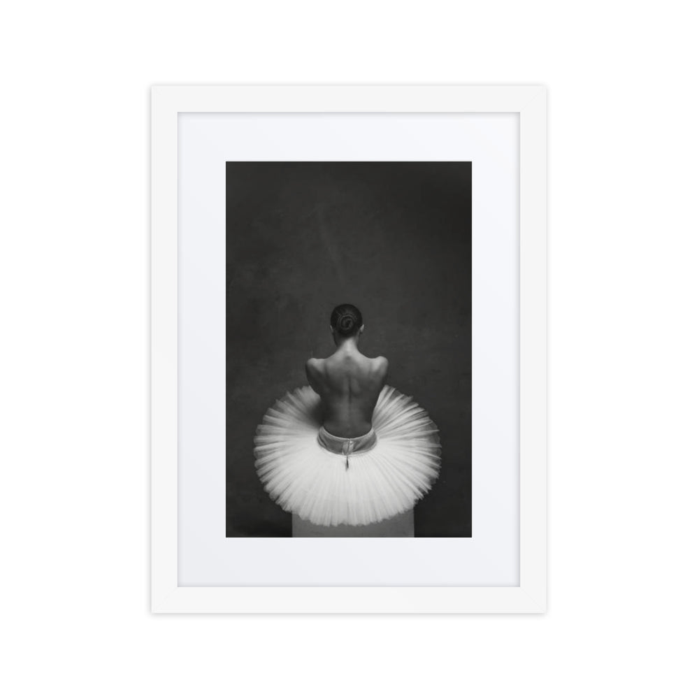 A powerful black-and-white portrait of a ballerina viewed from behind, showcasing her poised back and delicate tutu, embodying elegance and introspection.