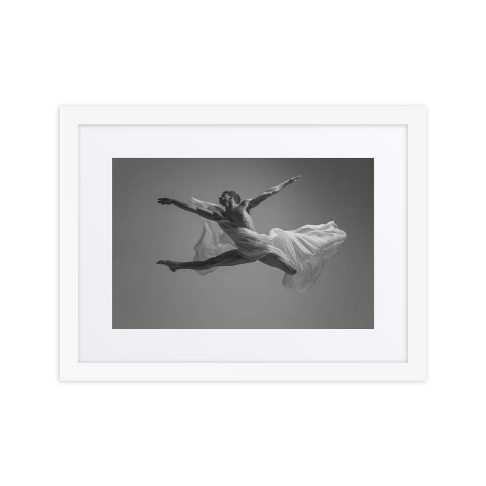 A captivating black-and-white photograph of a male dancer in mid-air, showcasing a powerful leap enveloped in flowing fabric, embodying strength and elegance in motion.