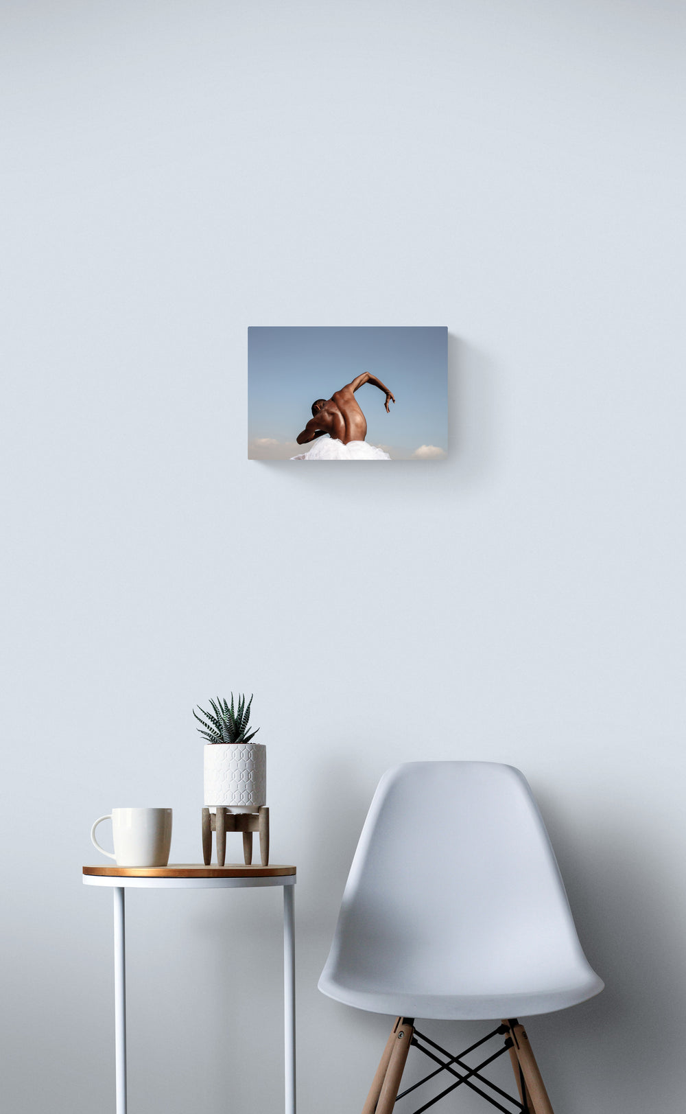 Dancer back, in the nature, blue sky, hand, black skin. Art photo print on the white wall.