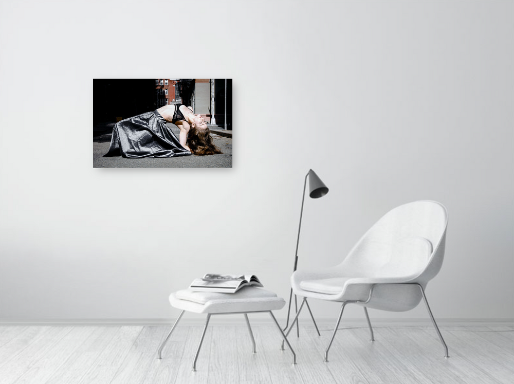 A black and white photograph of a female dancer in mid-air, captured in graceful movement.