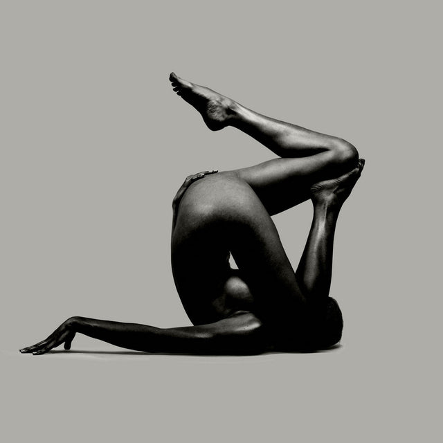 Unfolding leg extends from a compact posture; emergence from compression into the room.