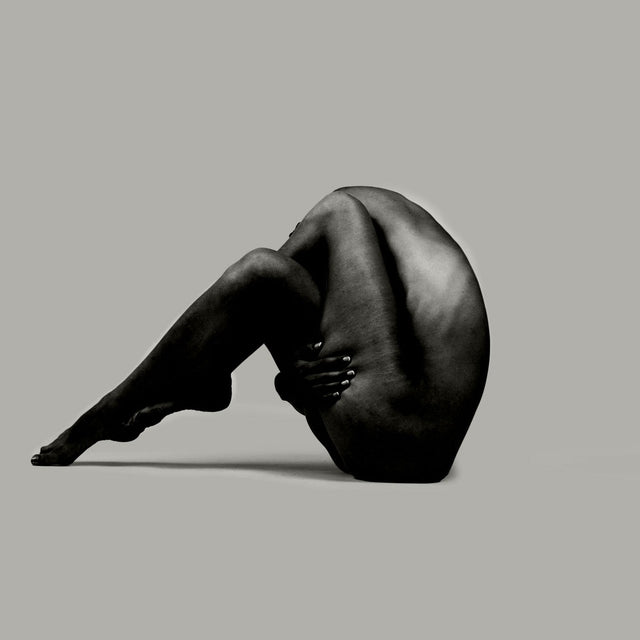 Coiled body turning to the side, tension building as the nascent shape gathers weight and direction.