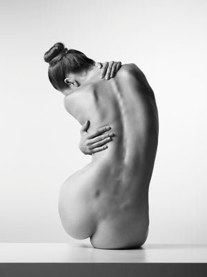 Black and white female nude photography, minimalist back portrait, fine art dance-inspired.