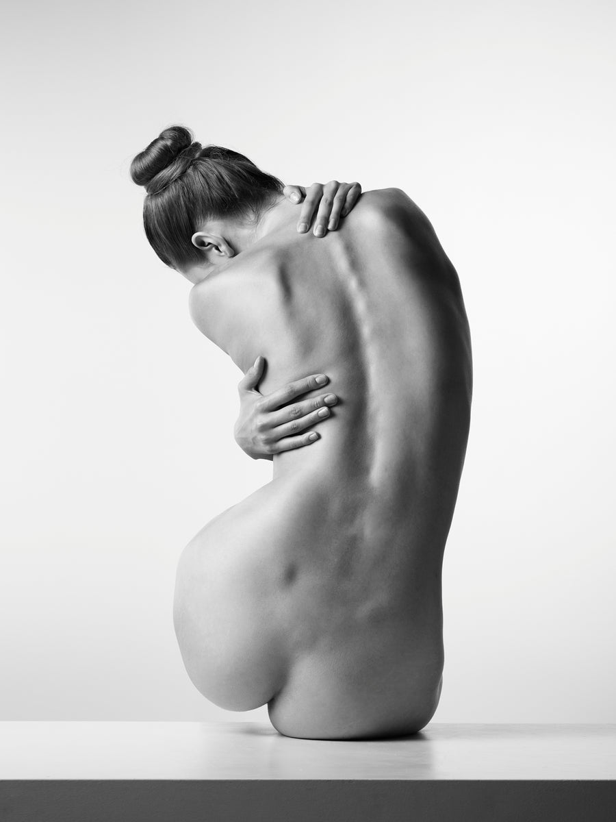 Black and white female nude photography, minimalist back portrait, fine art dance-inspired.