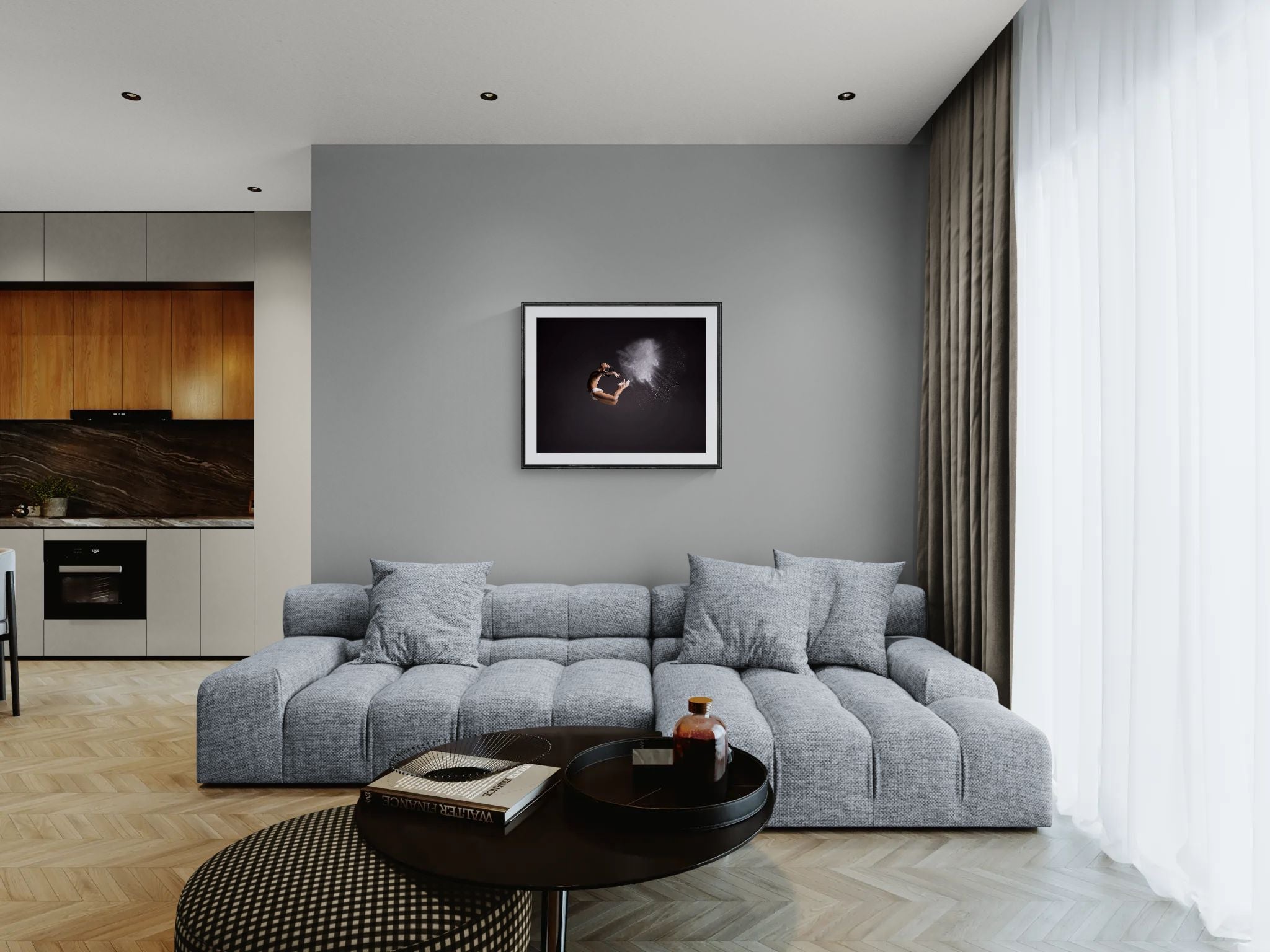 Framed Cloud Dancer print hanging above a low grey modular sofa in a modern open-plan living room with wood cabinetry and stone backsplash.