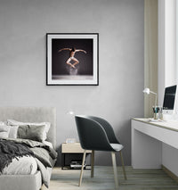 Cloud Dancer – Powder Leap framed print on a grey wall between a modern bed and white desk in a contemporary bedroom with soft neutral tones.