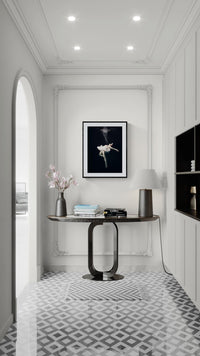 Framed fine art print Ethereal Descent displayed above a modern console table in a classic white hallway interior.