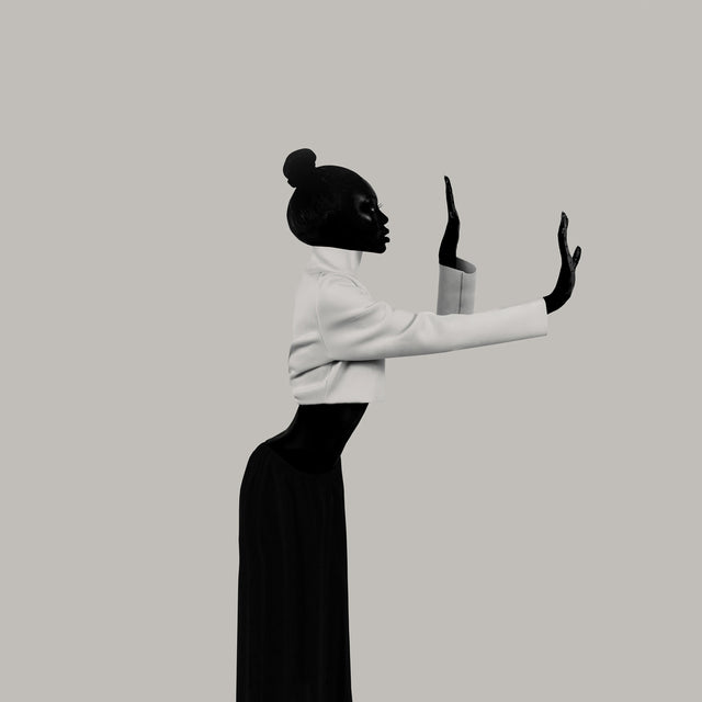 Profile figure in a tailored silhouette; wrist and elbow begin a clear, inward hinge of phrasing.