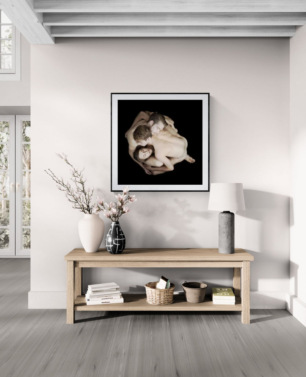 Mock-up showing the HEWMAN Collective limited edition fine art print by Nir Arieli displayed in a modern interior. The dancers appear in a sculptural group formation photographed on a dark background.