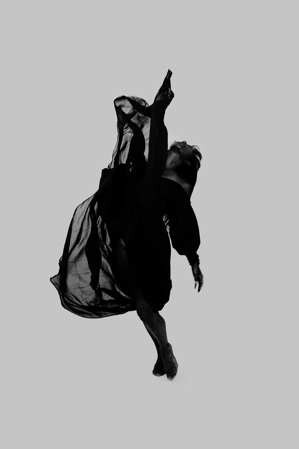 High ascent framed by billowing cloth; a dramatic vertical surge marks the visual climax.