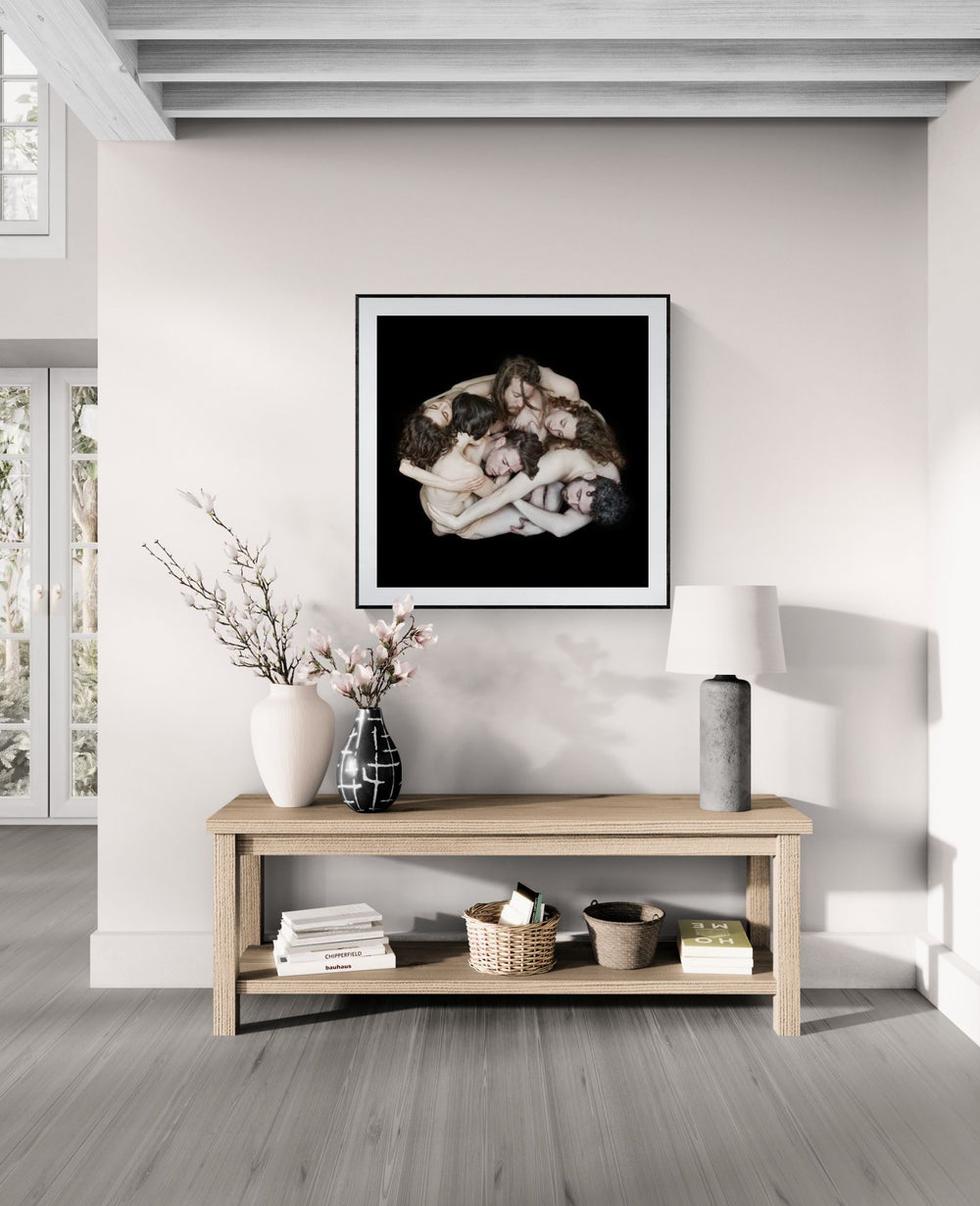 Mock-up showing The People Movers limited edition fine art print by Nir Arieli displayed in a modern minimalist interior. The dancers form a sculptural circular composition photographed in studio lighting.