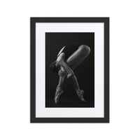 An artistic black-and-white photograph of a ballerina on pointe, gracefully arching her body into a mesmerizing pose.