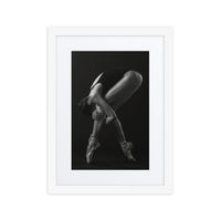 An artistic black-and-white photograph of a ballerina on pointe, gracefully arching her body into a mesmerizing pose.