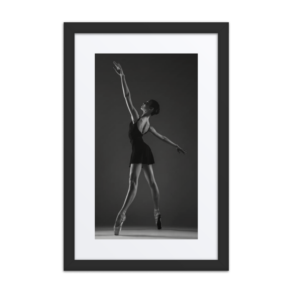 A striking black-and-white photograph of a ballerina in a poised and elegant pose, showcasing the timeless grace of classical ballet.