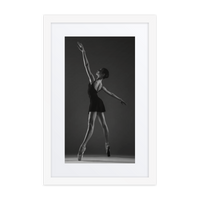 A striking black-and-white photograph of a ballerina in a poised and elegant pose, showcasing the timeless grace of classical ballet.