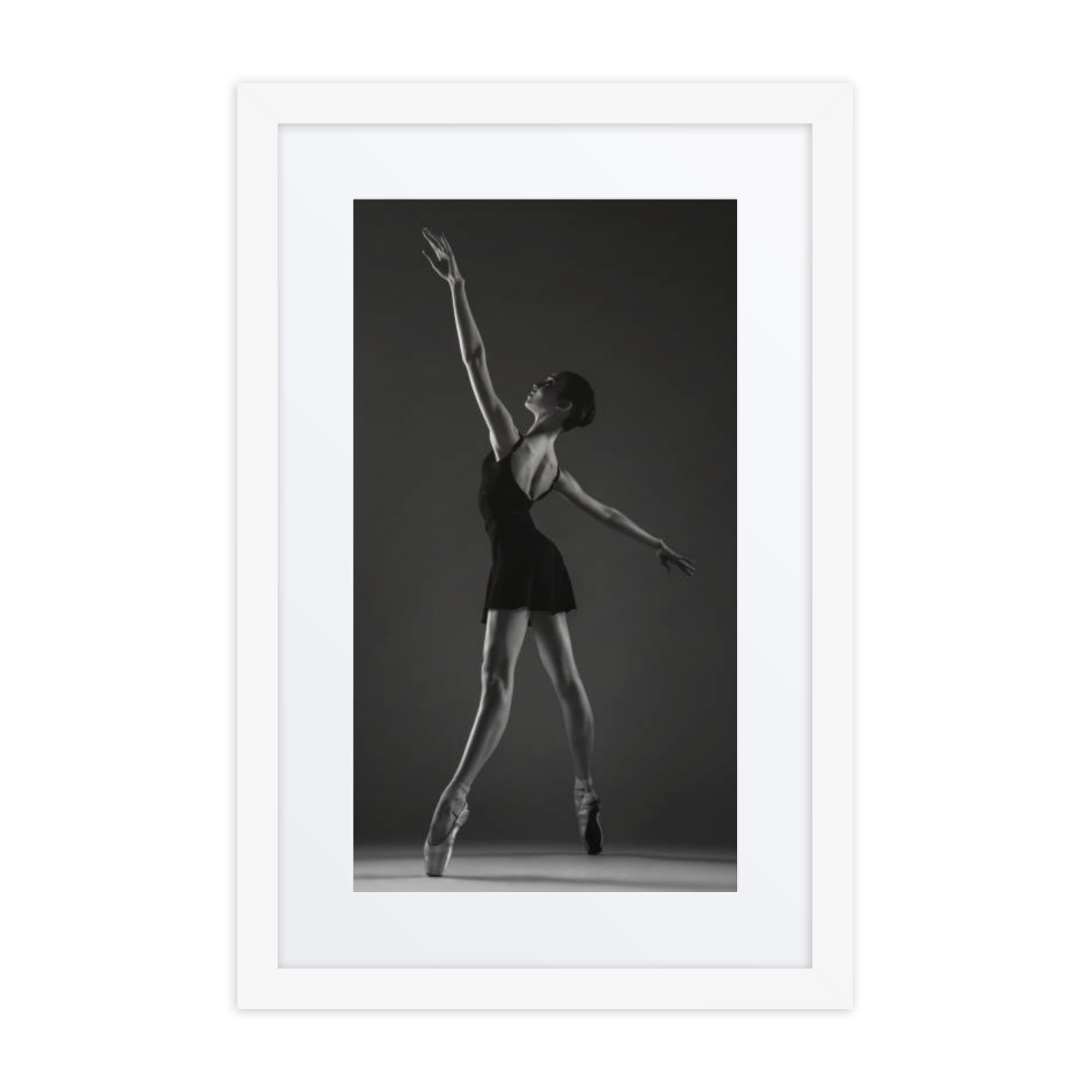 A striking black-and-white photograph of a ballerina in a poised and elegant pose, showcasing the timeless grace of classical ballet.