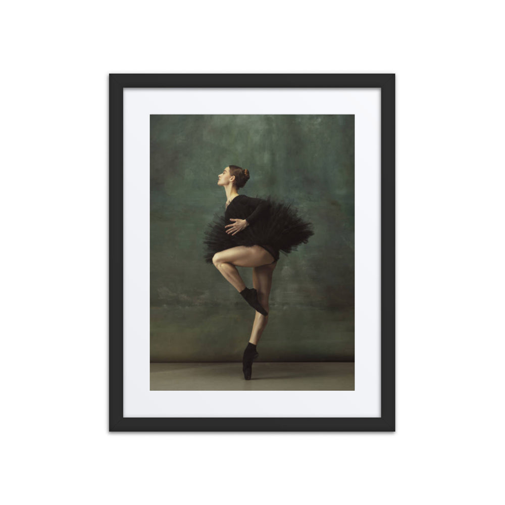 A poised ballerina wearing a black tutu captured mid-pose, embodying grace and precision against a soft green background.