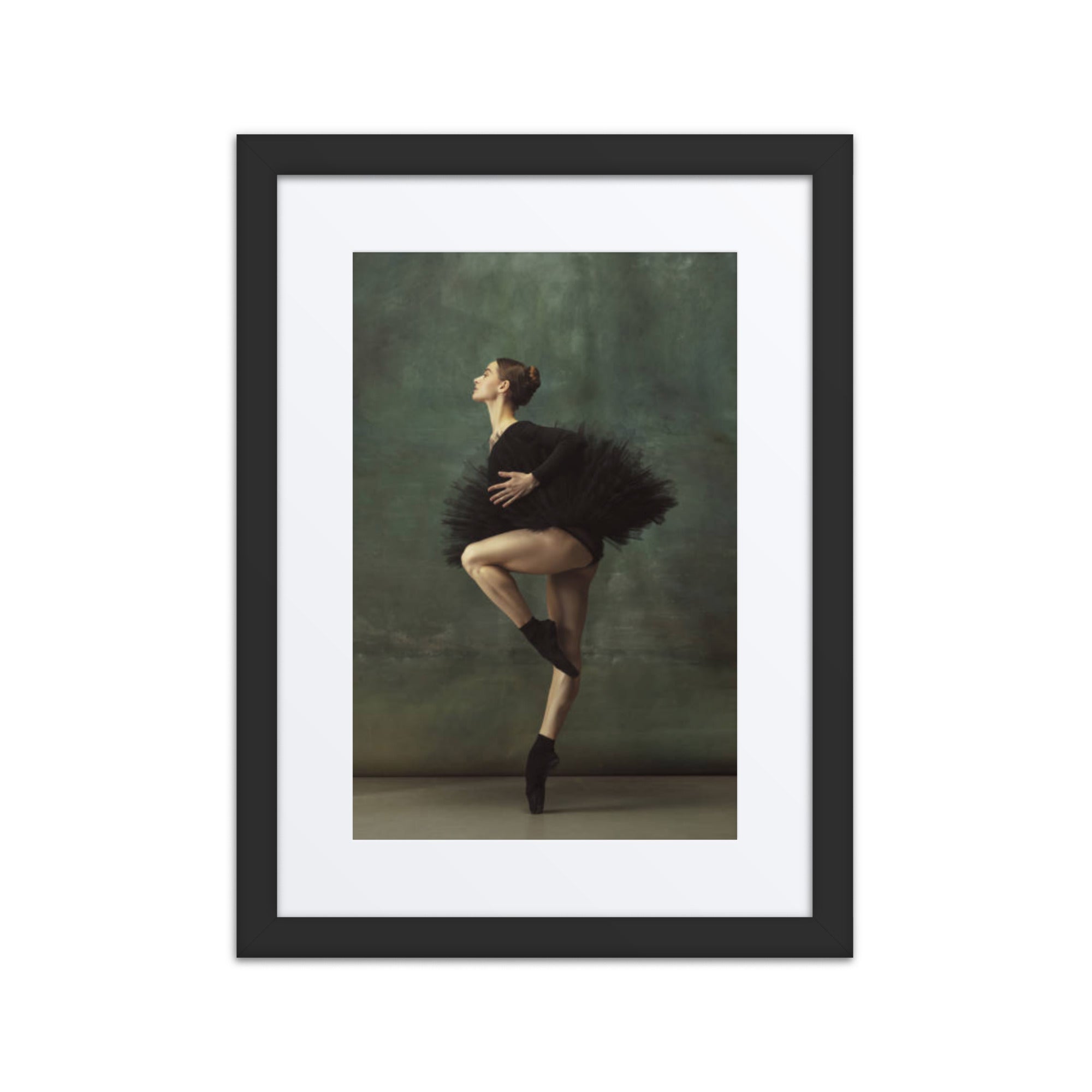 A poised ballerina wearing a black tutu captured mid-pose, embodying grace and precision against a soft green background.