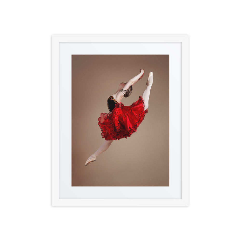 A captivating photograph of a ballerina mid-leap, dressed in a vibrant red tutu with black accents. The dynamic motion and vivid colors highlight the energy and passion of classical ballet.