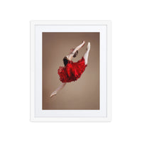 A captivating photograph of a ballerina mid-leap, dressed in a vibrant red tutu with black accents. The dynamic motion and vivid colors highlight the energy and passion of classical ballet.