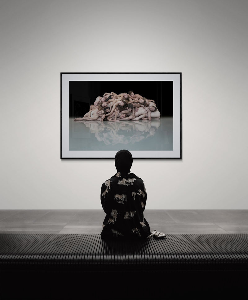 Gallery interior with dance photography print centered at seated viewer eye level, archival framing on Cloud Dancer walls