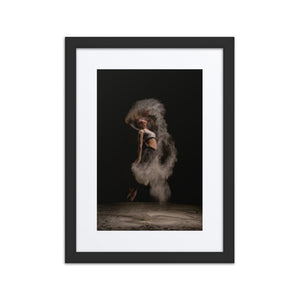 A dramatic photograph of a dancer enveloped in a swirl of dust against a dark backdrop, showcasing the raw power and dynamic energy of movement.