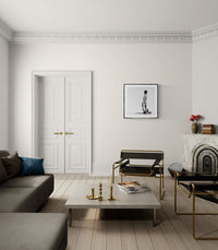 Modern living room with gray sofa, coffee table, and decorative items.