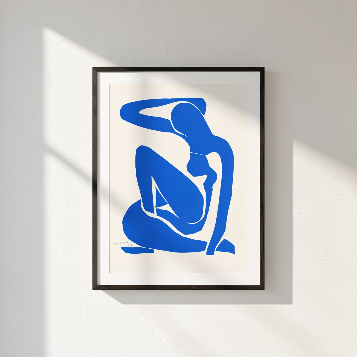 Henri Matisse Nu Bleu I (Blue Nude I), 2007, Museum Black framed presentation on a sunlit white wall.