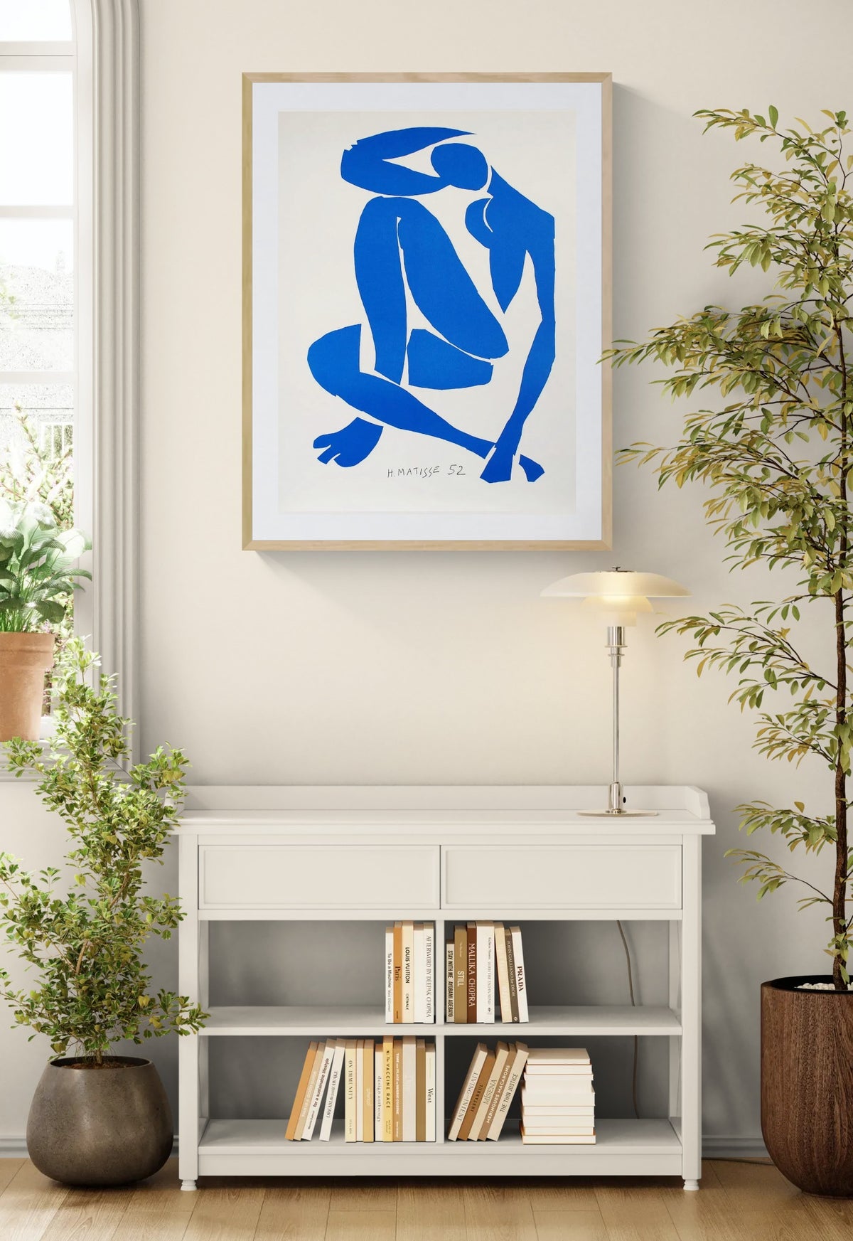 Henri Matisse Nu Bleu IV (Blue Nude IV), 2007, in a Natural Oak frame above a console in a bright interior.