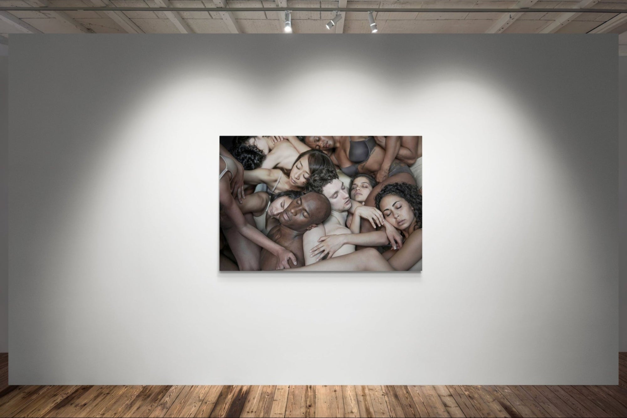 Artistic photograph of a group of people huddled together on a wall in an art gallery.