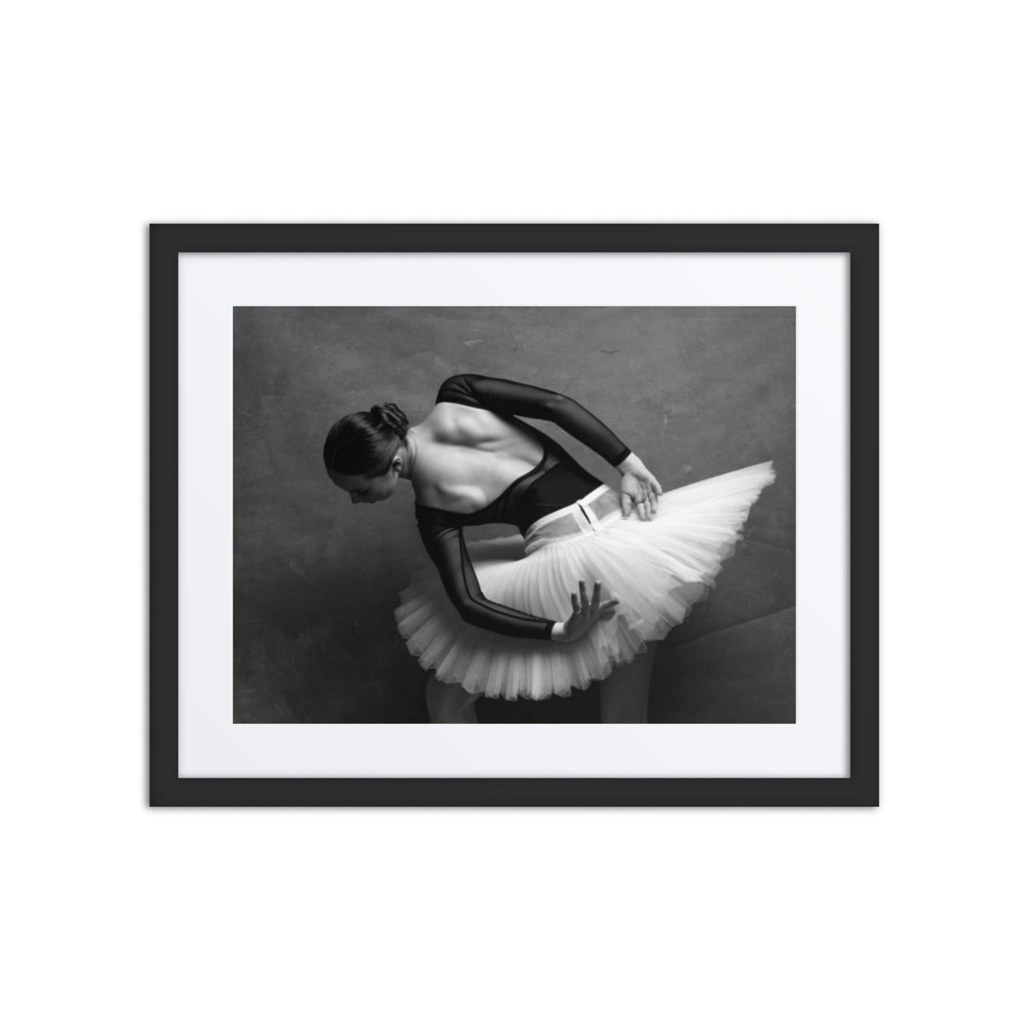 A ballerina captured in a quiet and graceful moment, bending and adjusting her tutu with delicate care. The soft lighting highlights her poised, elegant figure, emphasizing the quiet strength and intimate connection to the art of ballet.