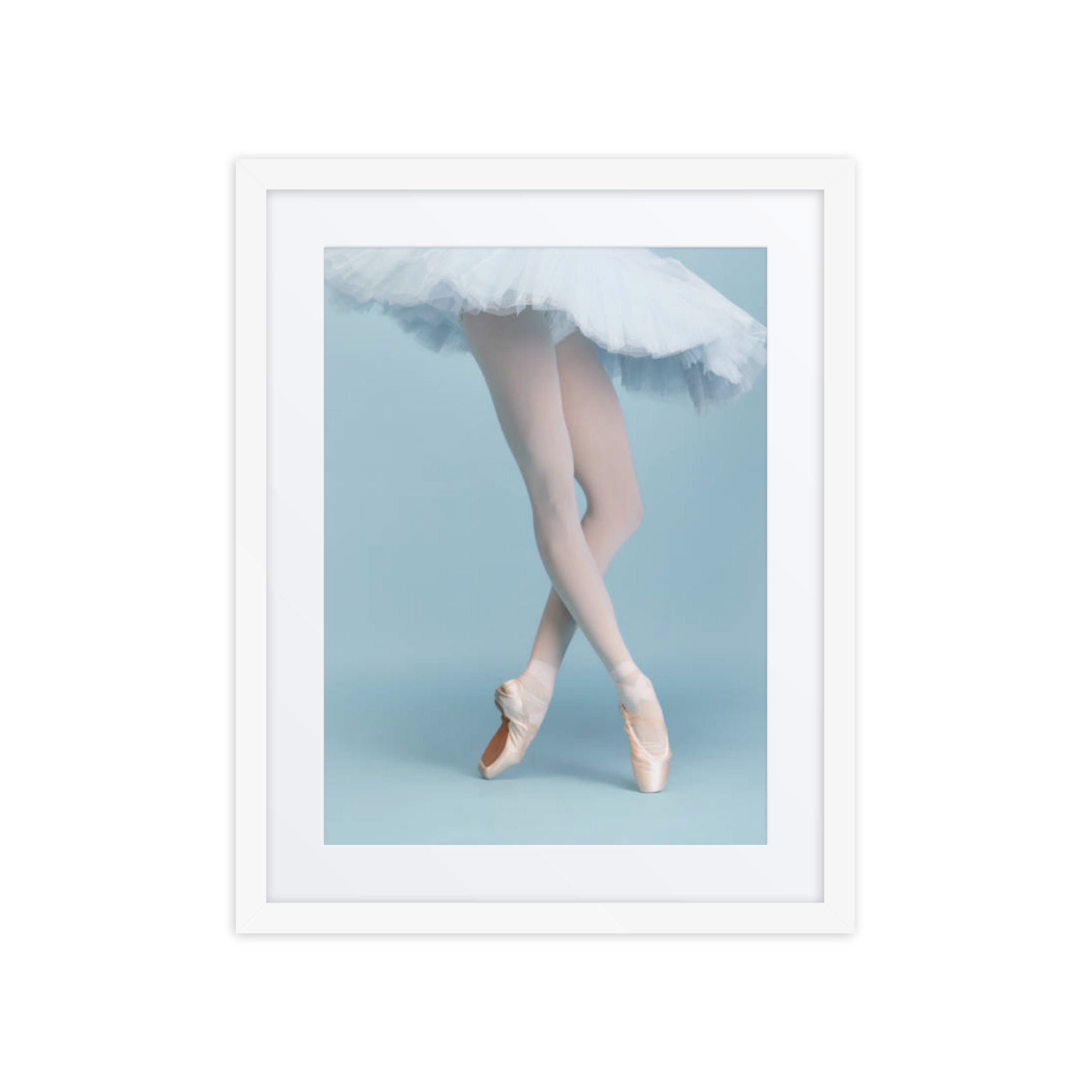 A ballerina on pointe, her legs poised in a classical pose, with soft, flowing tulle creating a delicate contrast against a pastel blue background. The image captures the elegance and precision of ballet, evoking a timeless sense of grace and beauty.