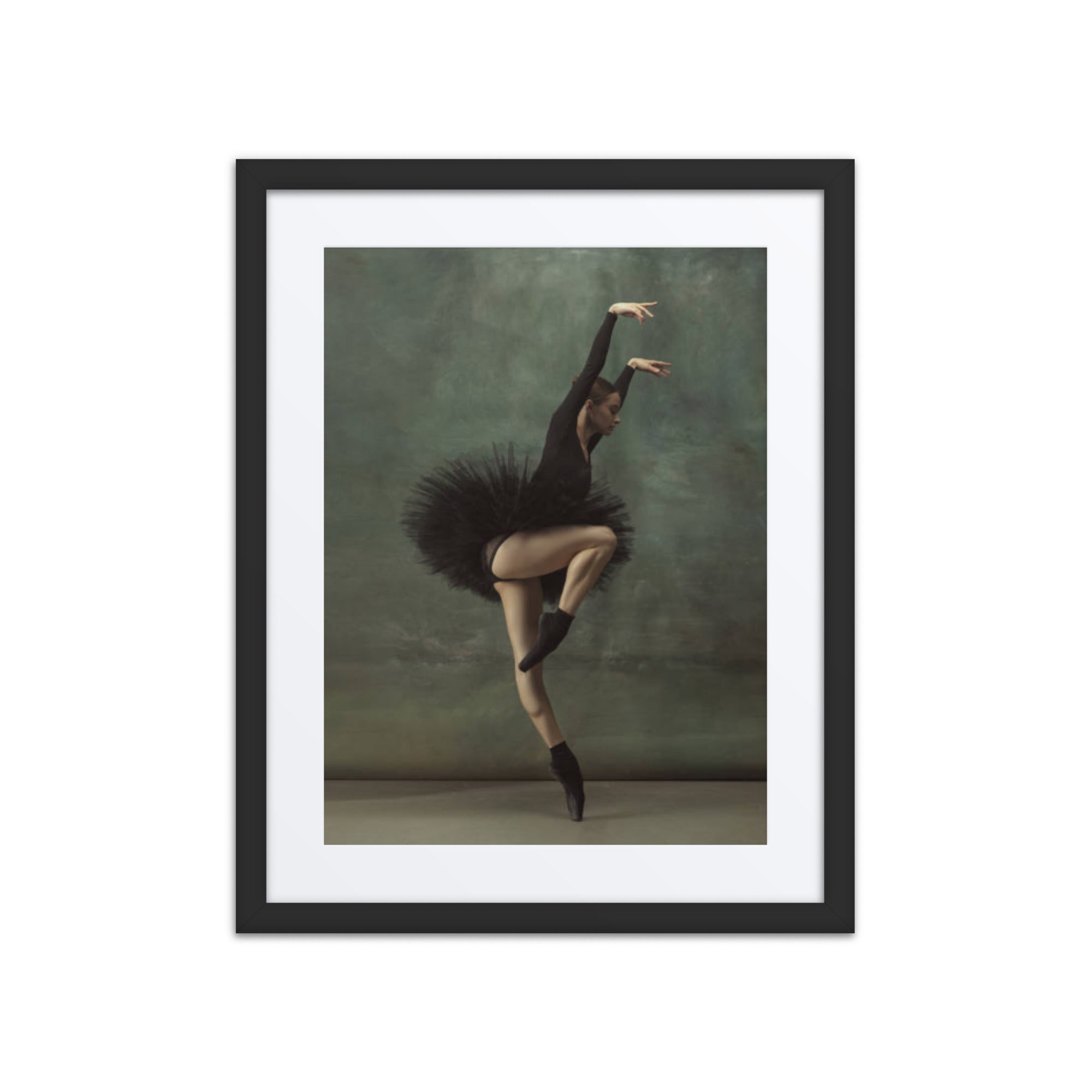 A poised ballerina in a dramatic black tutu, captured mid-performance against a textured green backdrop. The composition exudes an aura of mystery and elegance, highlighting the dancer’s precise technique and expressive movement.