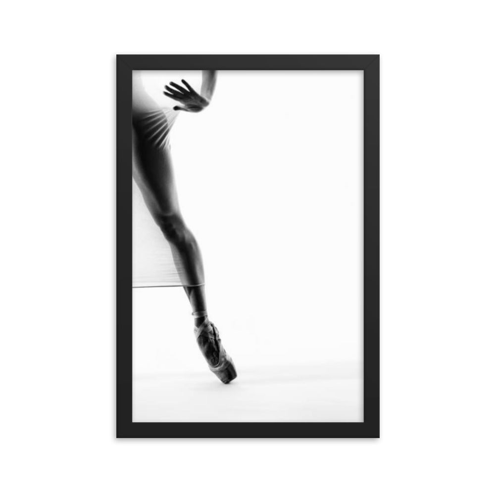 A striking black-and-white fine art photograph featuring a dancer's legs en pointe, showcasing minimalist elegance and precision in motion.