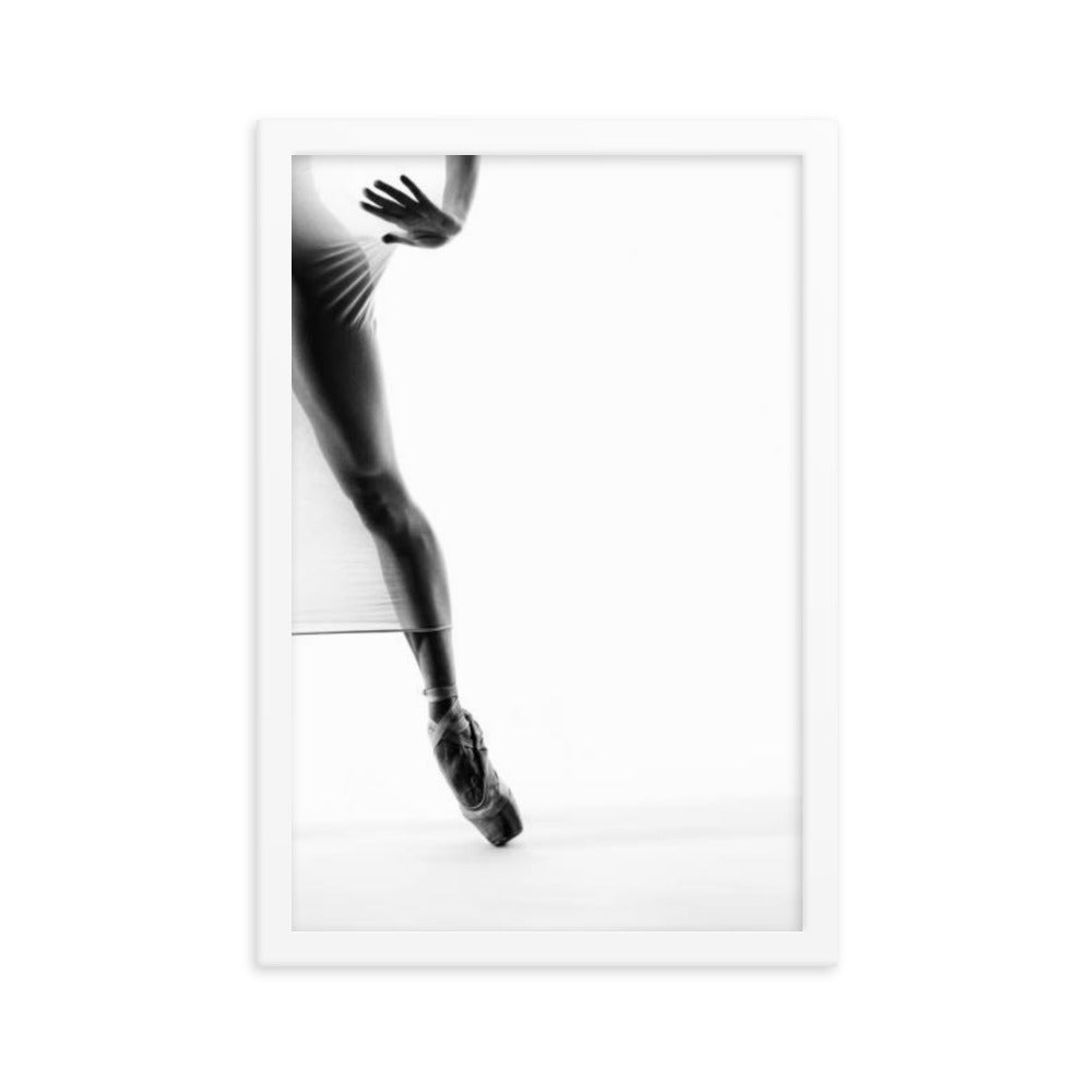 A striking black-and-white fine art photograph featuring a dancer's legs en pointe, showcasing minimalist elegance and precision in motion.