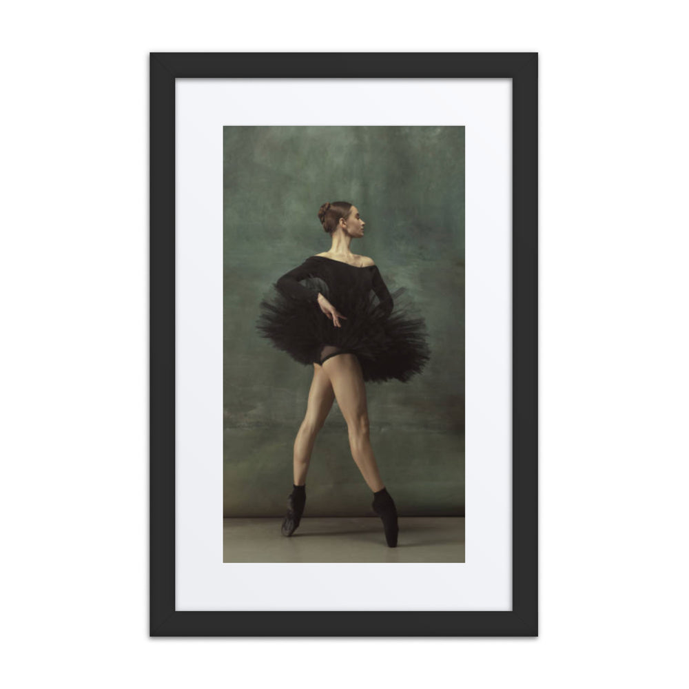 A graceful ballerina in a black tutu, poised elegantly en pointe. The image captures the dancer’s strength, balance, and refined artistry against a softly textured background.