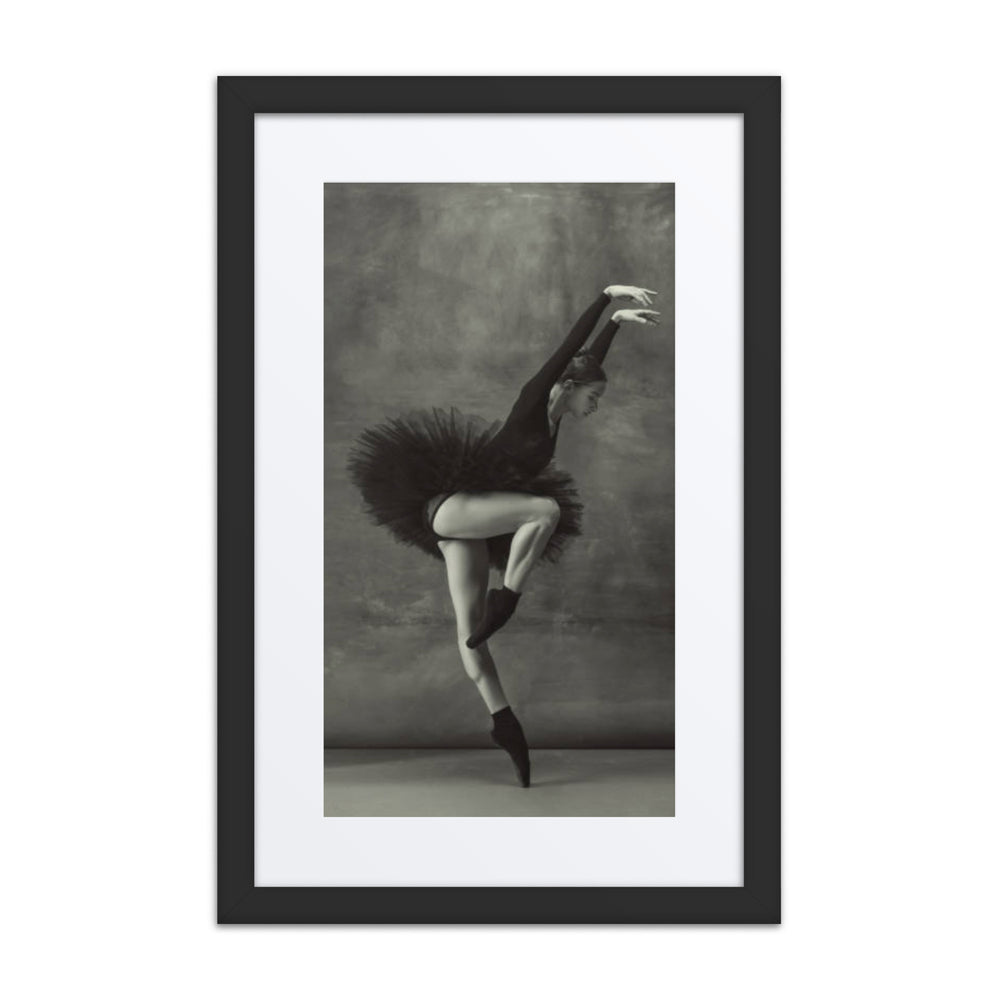 A graceful ballerina in a black tutu, performing a delicate en pointe pose. The black-and-white palette enhances the contrast of motion and stillness in this stunning composition.