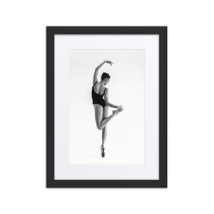 Framed fine art poster titled 'Poised Ascent,' featuring a ballerina in an elegant classical ballet position. The minimalist black-and-white composition captures grace and movement, ideal for a modern or traditional art collection.