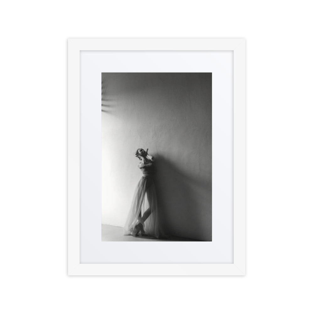 A monochrome photograph of a ballerina in a quiet pose, covering her ears, evoking themes of silence and introspection.