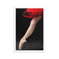 A refined close-up of a ballerina’s pointe shoe under a red lace-trimmed tutu, showcasing the detail and discipline of classical ballet.