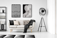 Modern living room with a white sofa, black and white decor, and a stylish floor lamp.
