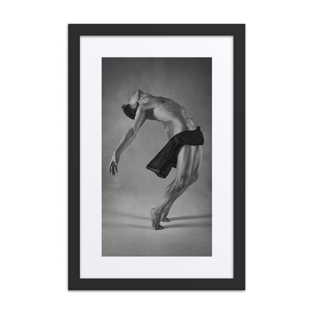 A striking black-and-white photograph of a male dancer arching his back in a moment of complete surrender, draped in a flowing fabric. The image conveys raw emotion, fluidity, and the beauty of vulnerability in dance.