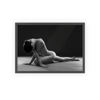 Nude woman doing yoga pose in black and white in black frame on a white wall
