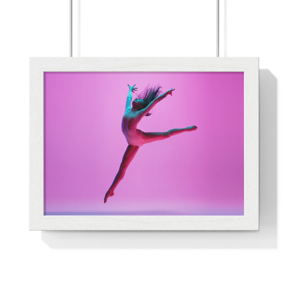 Female dancer performing a jump with her arms open in a pink set lighting