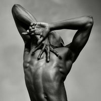Close-up photograph of a male dancer and hands from the artwork J. by Sasha Onyshchenko, showing sculptural musculature and expressive hand placement in monochrome fine art style.