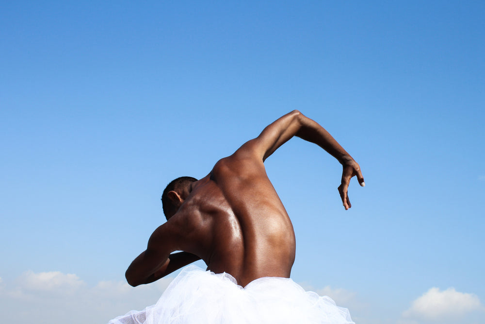 Dancer back, in the nature, blue sky, hand, black skin. Art photo print.
