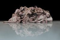 Limited edition archival pigment print Nederlands Dans Theater 2 by Nir Arieli from the Flocks series, a compact group of nude dancers lying together and reflected on a pale floor against a deep black background, museum quality dance photography for contemporary art collectors and interior design projects.