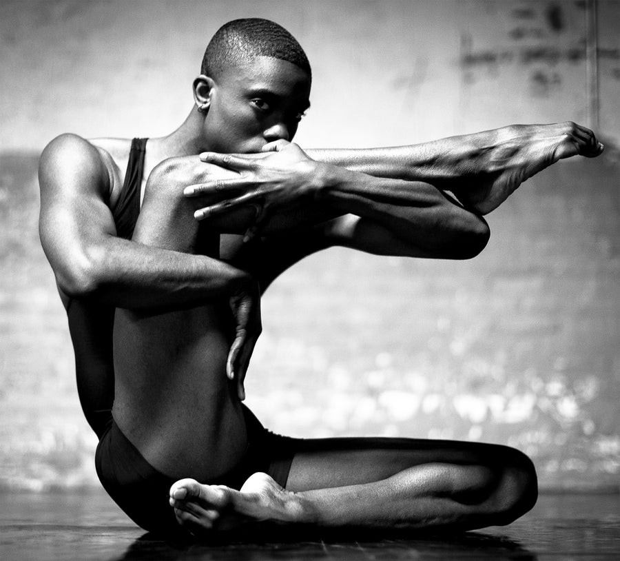 Close-up of a male dancer's face during a performance, showing intense focus and emotion.